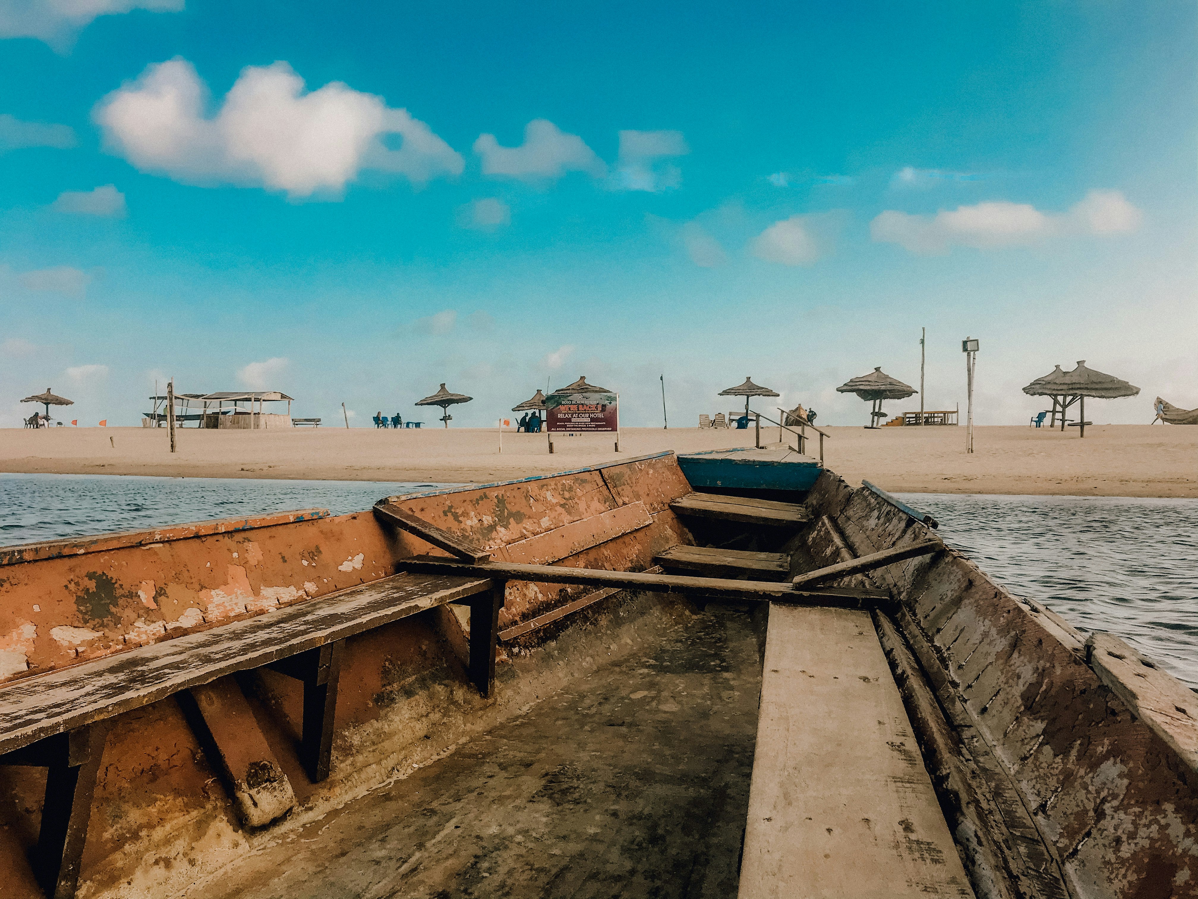 brown wooden bench on beach during daytime